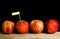 Red apples and yollow label put on wooden with black background