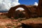 Red arch against a blue sky and white clouds