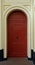 Red Arched Door with Golden Trim Details