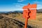 Red arrow and sign point guiding hikers.