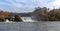 A red arrow train stops on top of the bridge at Rhine Falls to view the wonderful waterfall landscape and the castle at Laufen in