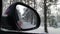 Red automobile in motion. View in the rear view side mirror of a auto, driving a red car along the track,