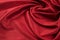 Red background luxury cloth or wavy folds of grunge silk texture satin velvet