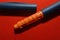 On a red background, a syringe pen for the introduction of insulin to a patient with diabetes, endocrinological diseases