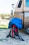 red backpack and sleeping bag near a retro caravan