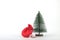 Red bag under fir tree  on white background. Christmas gift concept. Full Santa Claus red bag