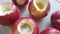 Red baked apples with wet sugar inside. Apples in a glass baking dish