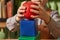 A red ball and a blue cube in the hands of a child