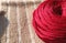 A red ball of yarn crochet on the carpet