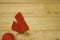 Red ball of yarn with spokes on a wooden background, free space for text