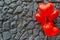 Red balloon heart on a background of gray stone.