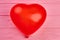 Red balloon in a shape of heart.