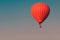 Red balloon in the sky.