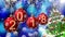 Red balls with numbers 2018 hanging on the background of a blue bokeh and a rotating Christmas tree