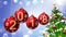 Red balls with numbers 2018 hanging on the background of a blue bokeh and a rotating Christmas tree .