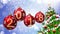 Red balls with numbers 2018 hanging on the background of a blue bokeh and a rotating Christmas tree 3d rendering.