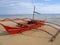 Red banca outrigger fishing boat philippines