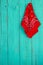 Red bandana hanging on blank antique teal blue wood door
