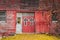 Red barn double doors are adorned in large gothic-style crosses surrounded by fall foliage