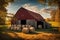 Red barn with hay bales on the field at sunset in autumn