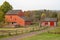 Red barn and log cabin on dirt road at historic Daniel Boone Homestead