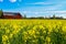 Red barn near rapeseed field in Sweden