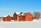 Red Barn and Outbuildings in Winter Countryside with Snow