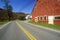 Red barn by side of Scenic Route 100 in autumn, VT