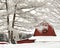 Red Barn with snow covered trees in winter