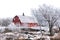 Red barn surrounded by tree covered hoar frost