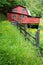 Red barn surrounded by yellow buttercups in spring