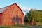 Red barn with tree shadow