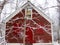 Red Barn in the winter in a forest; peaceful