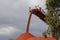 Red bauxite falling off conveyor onto huge red pile of bauxite near Weipa QLD
