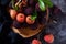 red bayberry(waxberry) and lychee placed together on marble tabletop, dark indoor background