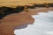 The Red Beach or Playa Roja with pure white wave foam from the Pacific ocean, Paracas National Reserve in Peru