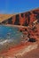 Red beach at Santorini, Greece with sunbathing hut & sundeck for visitors popular for its titular red hued sand