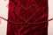 Red beads making heart on scarlet velvet fabric