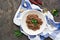 Red bean lobio, a hearty second course with half mashed beans with fried onions, garlic and spices in a white ceramic plate on a