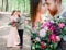 Red bearded groom stands with bride in peach dress