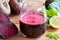 Red beet juice in a glass on a wooden background