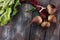 Red Beetroot with herbage green leaves on rustic background. Org