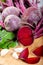 Red beetroot with herbage green leaves on wooden background