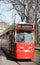 Red and Beige colored streetcar GLT as tram on the Street named Lange Vijverberg in The Hague.