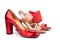 Red, beige and orange female shoes and sandals with high heels for sale side view on white background  close up