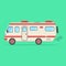 Red and beige travel camper van on green background