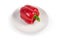 Red bell pepper on the saucer on a white background