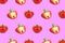 Red bell peppers, saturated pink background