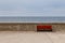 Red bench on seafront promenade, Baltic Sea.