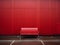 a red bench sitting in front of a red wall